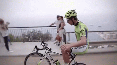 A Man Riding A Bike With The Word Cannondale On His Pants GIF