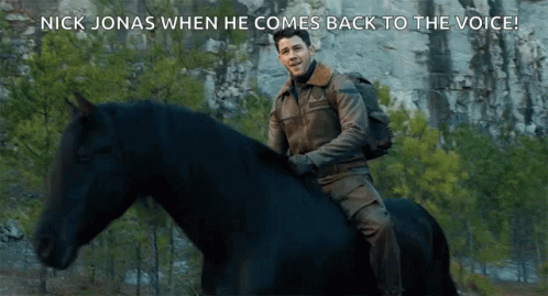 A Man Riding A Black Horse With The Words Nick Jonas When He Comes Back To The Voice Below Him GIF