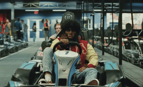 A Man Riding A Go Kart With The Number 7 On The Front GIF