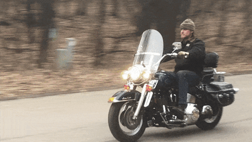 a man riding a harley davidson motorcycle with a license plate that says rb
