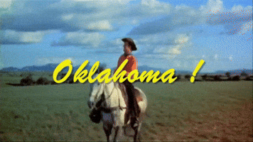 A Man Riding A Horse In A Field With Oklahoma Written In Yellow Letters GIF