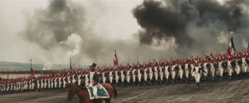 A Man Riding A Horse Leads A Large Military Parade GIF