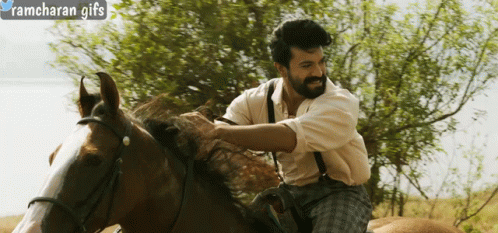 A Man Riding A Horse With Ramcharan Gifs Written In The Corner GIF