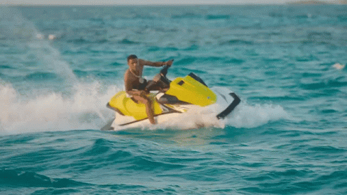 A Man Riding A Jet Ski In The Ocean GIF