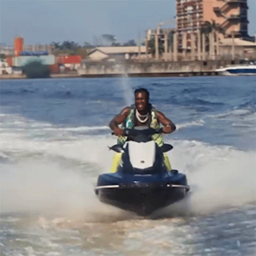 A Man Riding A Jet Ski In The Ocean GIF