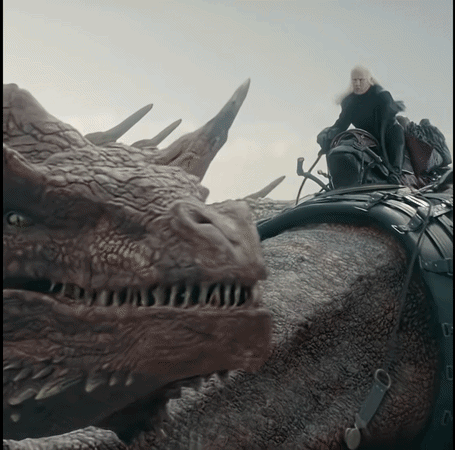 A Man Riding On The Back Of A Dragon With A Sword GIF