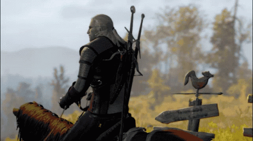 A Man Riding On The Back Of A Horse With A Sword On His Back GIF