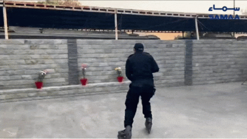 A Man Rollerblading In Front Of A Wall With The Word Samaa On It GIF