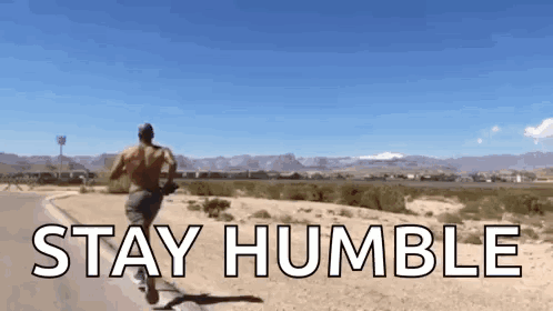 A Man Running Down A Road With The Words " Stay Humble " Written On It GIF