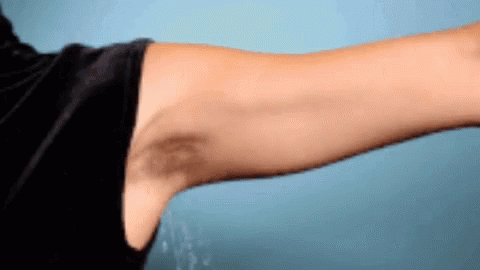 A Man 'S Arm With A Black Spot On It GIF