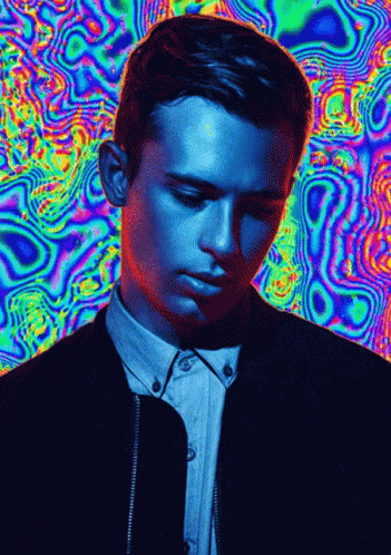 A Man 'S Face Is Against A Colorful Background GIF