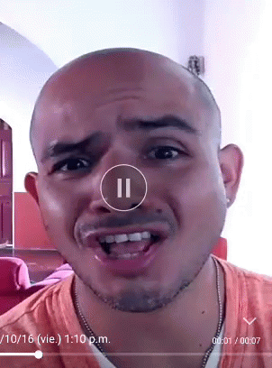 A Man 'S Face Is Shown In A Video With A Pause Button In The Corner GIF