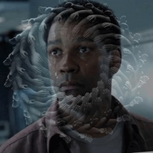 A Man 'S Face Is Surrounded By Many Hands Reaching Out Towards Him GIF
