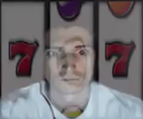 A Man 'S Face Is Visible In Front Of A Slot Machine . GIF