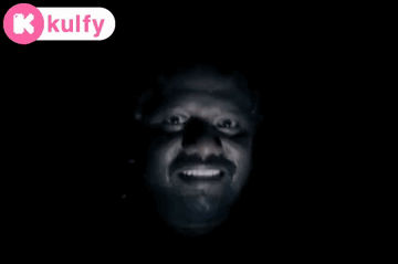 A Man 'S Face Is Visible In The Dark With A Kolfy Logo In The Corner GIF