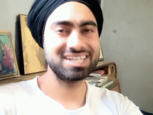 A Man's Staged Smile GIF