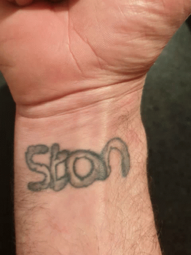 A Man 'S Wrist Has A Tattoo Of The Word Ston On It GIF