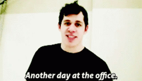 A Man Says " Another Day At The Office " In A Black Shirt GIF