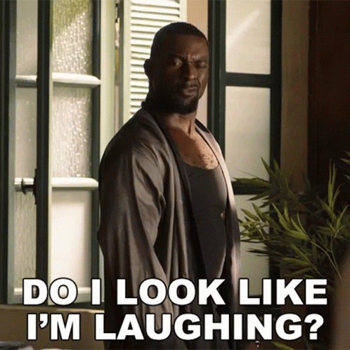 A Man Says Do I Look Like I 'M Laughing While Standing In Front Of A Window GIF