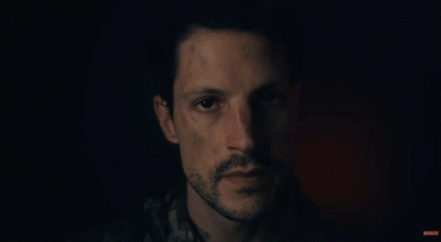 A Man Says " Glad You Made It Here Safely " In A Dark Room GIF