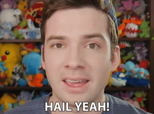 A Man Says Hail Yeah In Front Of A Stuffed Animal Shelf GIF