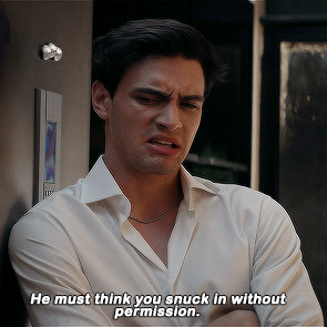 A Man Says He Must Think You Snuck In Without Permission While Leaning Against A Wall GIF