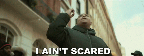 A Man Says I Ain 'T Scared In Front Of A Building GIF