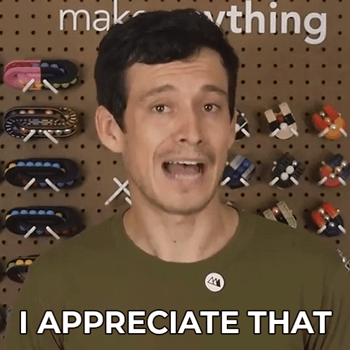 A Man Says " I Appreciate That " In Front Of A Wall Full Of Toys GIF