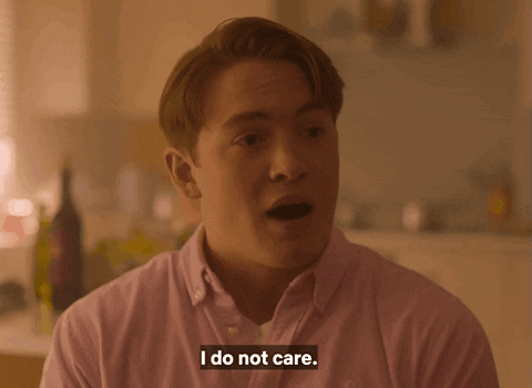 A Man Says I Do Not Care In A Pink Shirt GIF