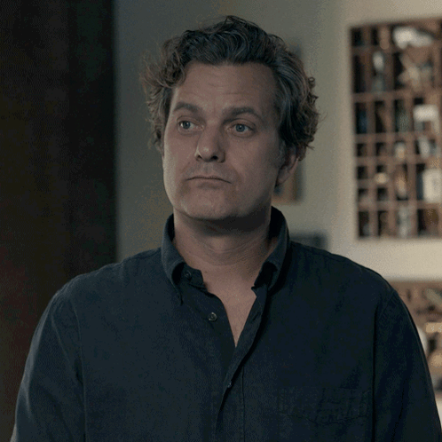 A Man Says I 'Ll Take It In Front Of A Wine Shelf GIF