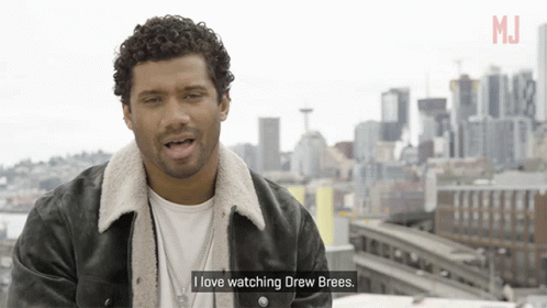 A Man Says I Love Watching Drew Brees In Front Of A City Skyline GIF