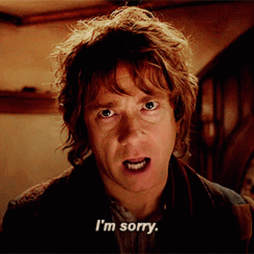 A Man Says I 'M Sorry In Front Of A Staircase GIF