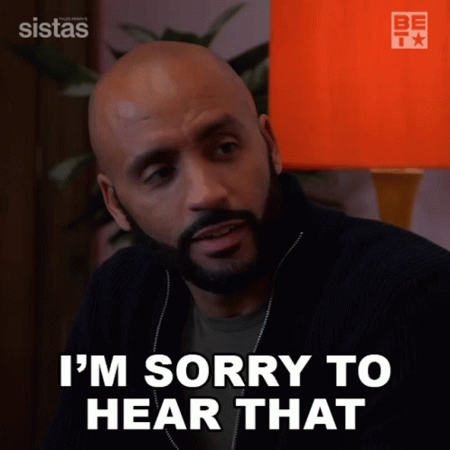 A Man Says I 'M Sorry To Hear That In Front Of An Orange Lamp GIF