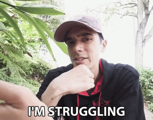 A Man Says I 'M Struggling In Front Of A Tree GIF