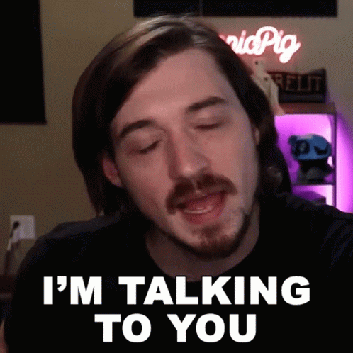 A Man Says I 'M Talking To You In Front Of A Sign That Says Pig GIF