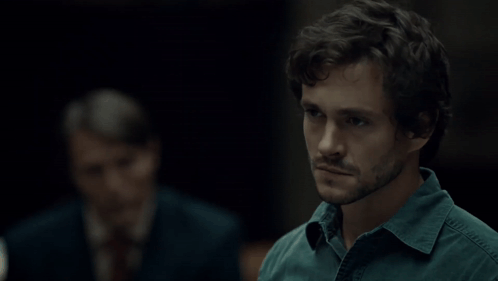 A Man Says " I Thought About It " In A Dark Room GIF
