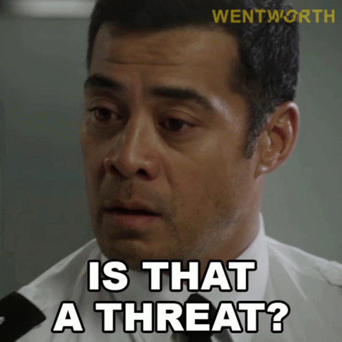 A Man Says " Is That A Threat " While Wearing A White Shirt And Black Tie GIF