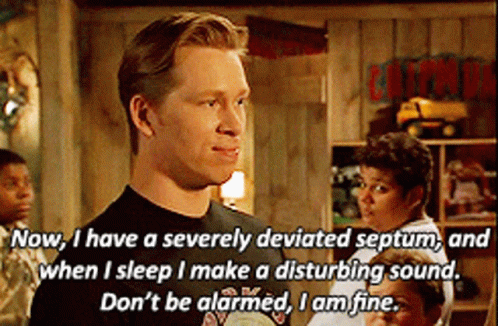 A Man Says " Now I Have A Severely Deviated Septum " In Front Of A Sign That Says Caution GIF