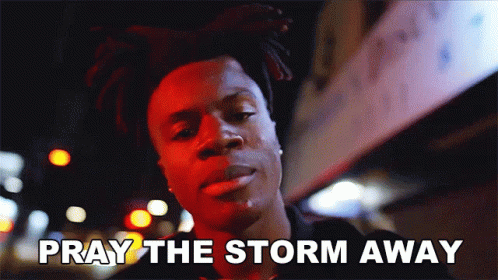 A Man Says Pray The Storm Away While Standing In Front Of A Building GIF
