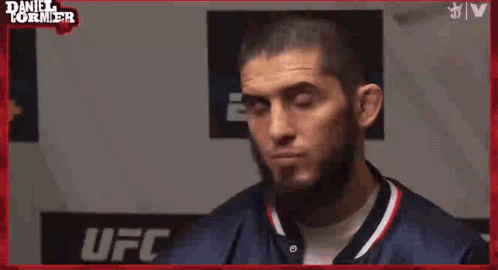A Man Says " Put Him Ankalaev " In Front Of A Ufc Sign GIF