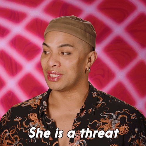 A Man Says She Is A Threat With A Pink Background GIF