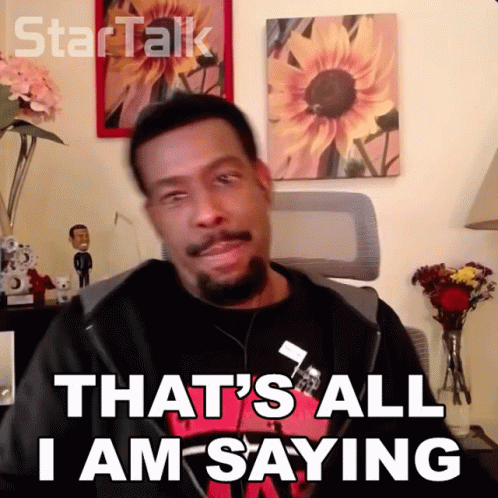 A Man Says That 'S All I Am Saying In Front Of A Wall With Sunflowers GIF