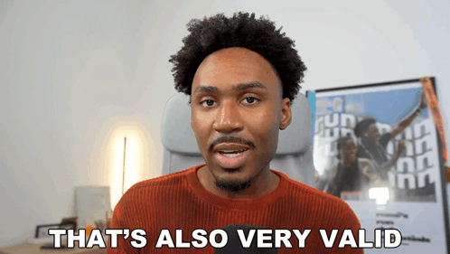 A Man Says " That 'S Also Very Valid " In Front Of A Poster GIF