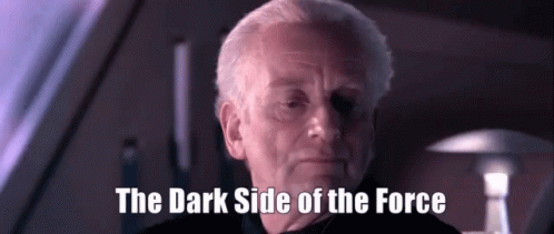 A Man Says The Dark Side Of The Force In A Dark Room GIF