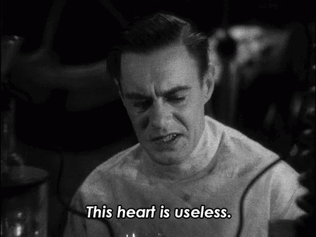 A Man Says " This Heart Is Useless " In A Black And White Scene GIF