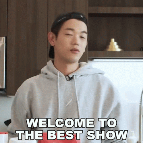 A Man Says Welcome To The Best Show While Standing In A Kitchen GIF