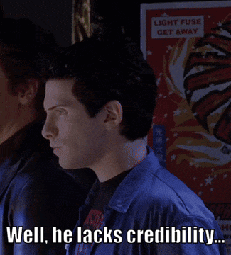 A Man Says Well He Lacks Credibility In Front Of A Sign That Says Light Fuse Get Away GIF