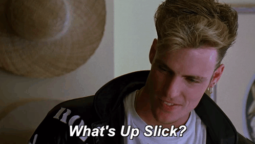 A Man Says " What 'S Up Slick " In Front Of A Hat GIF