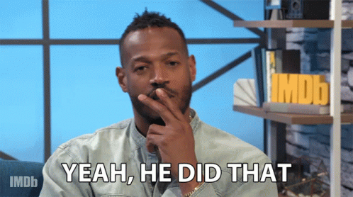 A Man Says Yeah He Did That In Front Of A Shelf With Imdb On It GIF