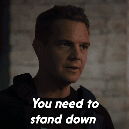 A Man Says You Need To Stand Down In Front Of A Wall GIF